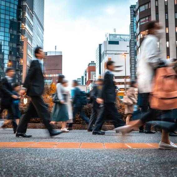 Blurred business people on their way from work